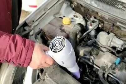Saç kurutma makinesiyle donan aracını ısıttı